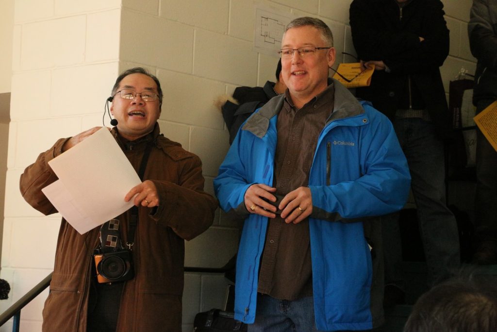 Pastors Jack Xie and Darren Milley stand together at a joint thanksgiving and building-renaming ceremony.