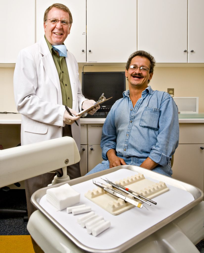 Tom Harle providing dental services. 