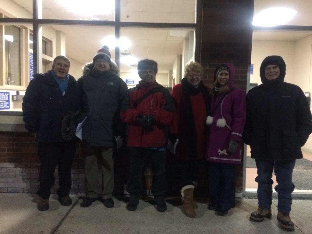 Volunteers stand in front of the Ottawa-Carleton Detention Centre. 