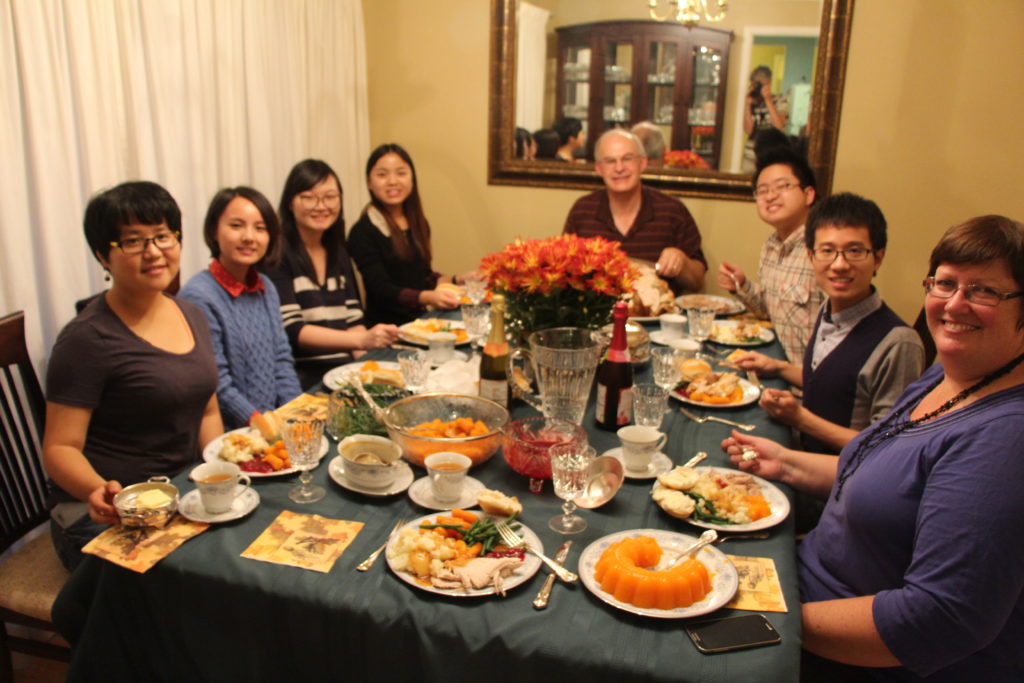 International students share a Christmas dinner with a Canadian family. 
