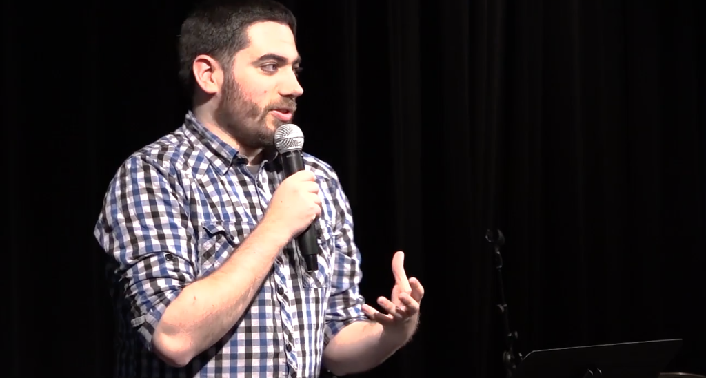 Josh Gilman speaks at a conference. 