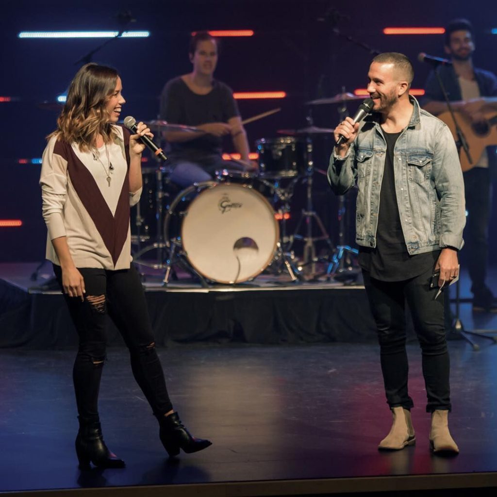 myChurch's founding pastors Caleb and Julie Davidson share the stage during a myChurch service. 