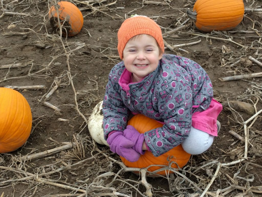 Marnie playing with a pumpkin, cancer free. 